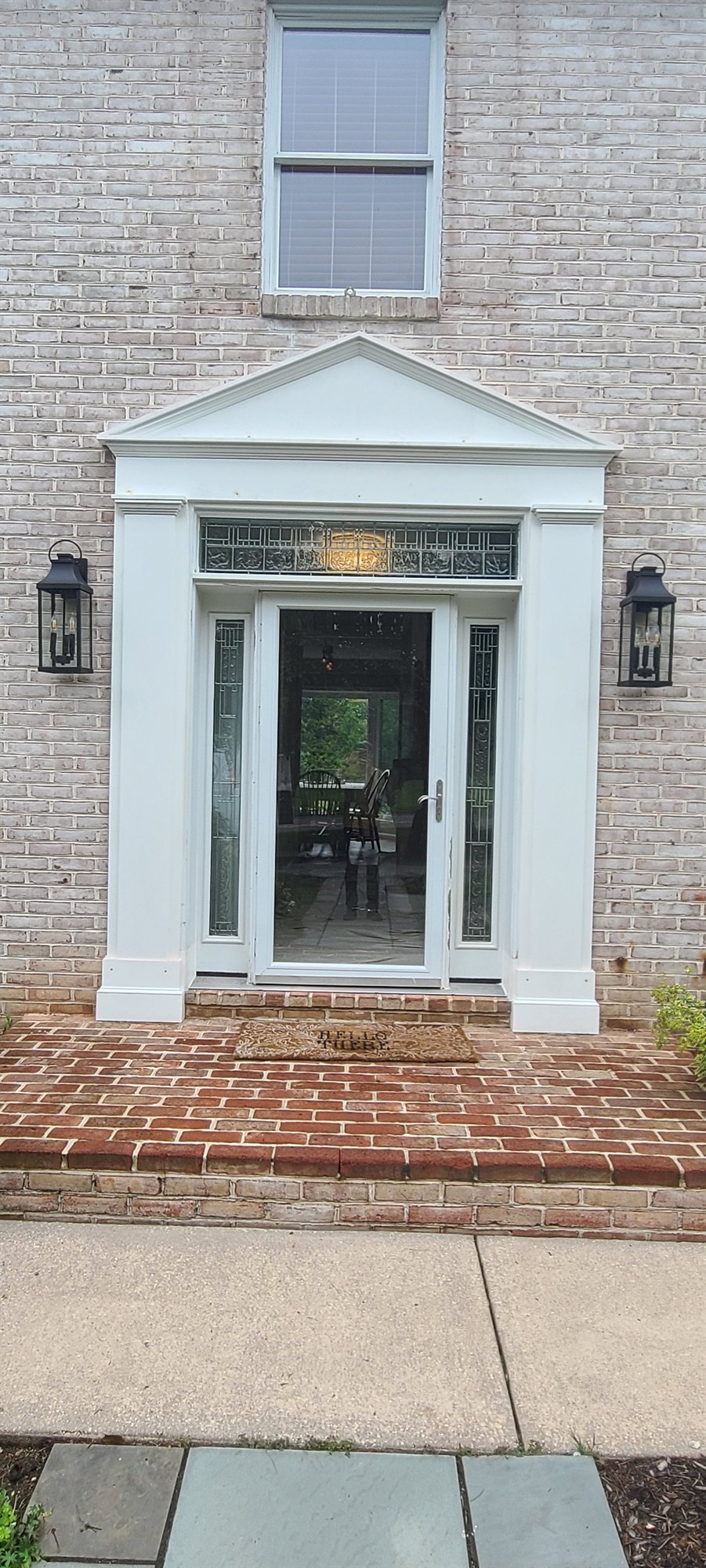 Front entry portico with peaked pediment, sidelights and transom in white millwork